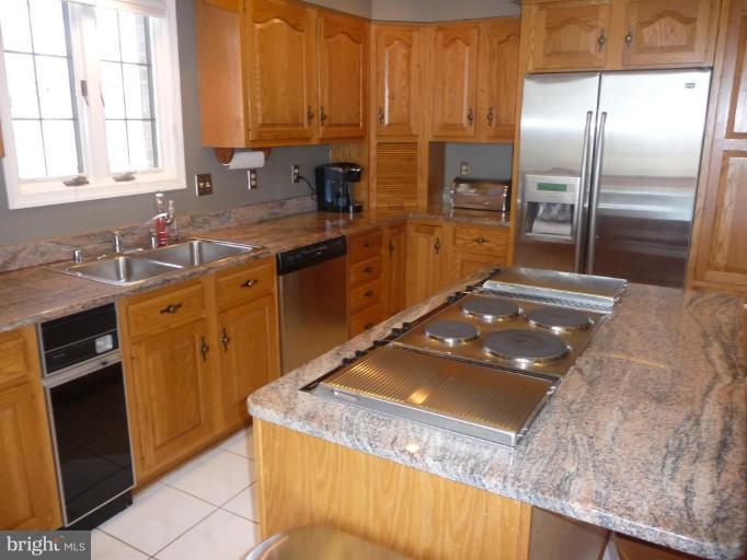 3165 Hickory Ridge Road Dunkirk, MD 20754 - Photo 4 of 30 a kitchen with kitchen island granite countertop a sink stove and refrigerator