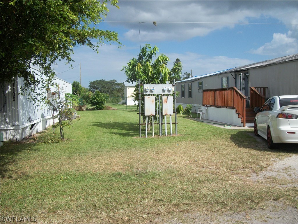 1002-1009 Nalls Road Clewiston, FL 33440 - Photo 18 of 19 a house view with a garden space