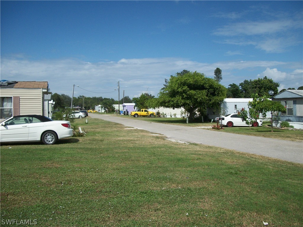 1002-1009 Nalls Road Clewiston, FL 33440 - Photo 7 of 19 a view of a street with cars