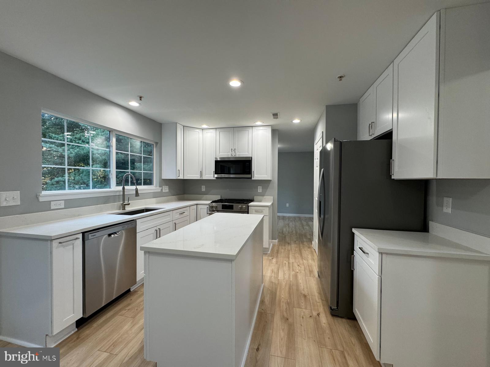 16107 Eckhart Road Bowie, MD 20716 - Photo 4 of 18 a kitchen with stainless steel appliances granite countertop a sink stove refrigerator and cabinets