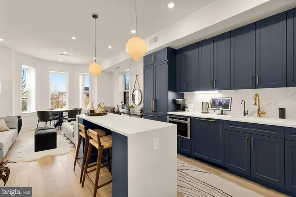 a kitchen with a sink a stove a dining table and chairs