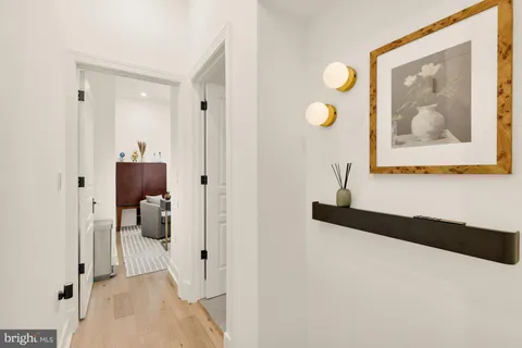 a view of a hallway with paintings on the wall