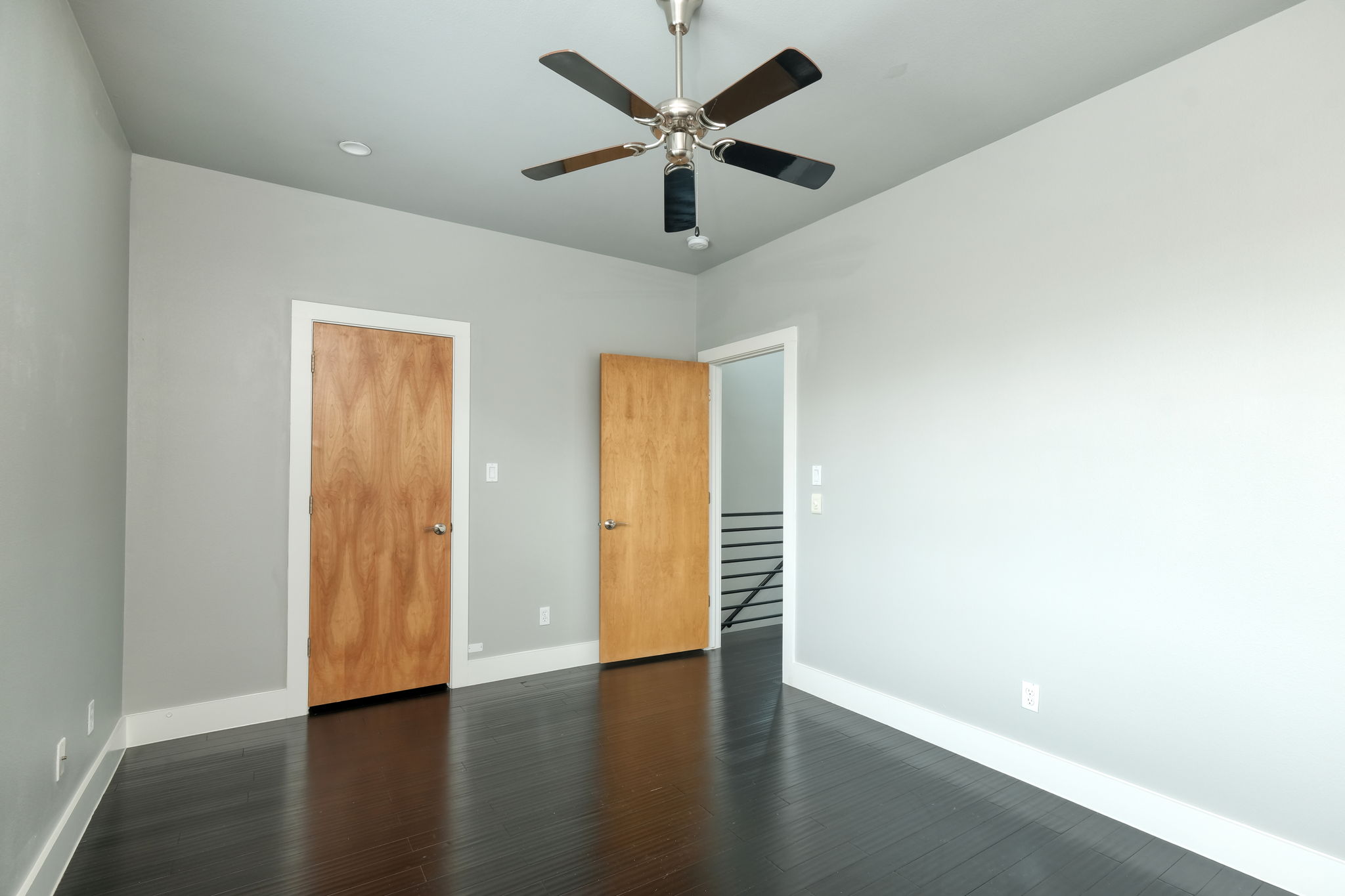 3000 Speedway Street, Unit E Austin, TX 78705 - Photo 9 of 16 Rich hardwood floors and a modern ceiling fan elevate this tranquil room.
