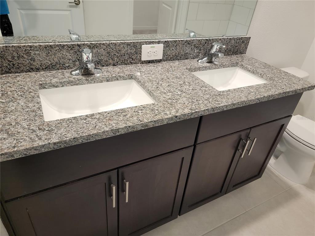 1844 Red Loop Lakeland, FL 33801 - Photo 19 of 24 a bathroom with a granite countertop sink a mirror and vanity