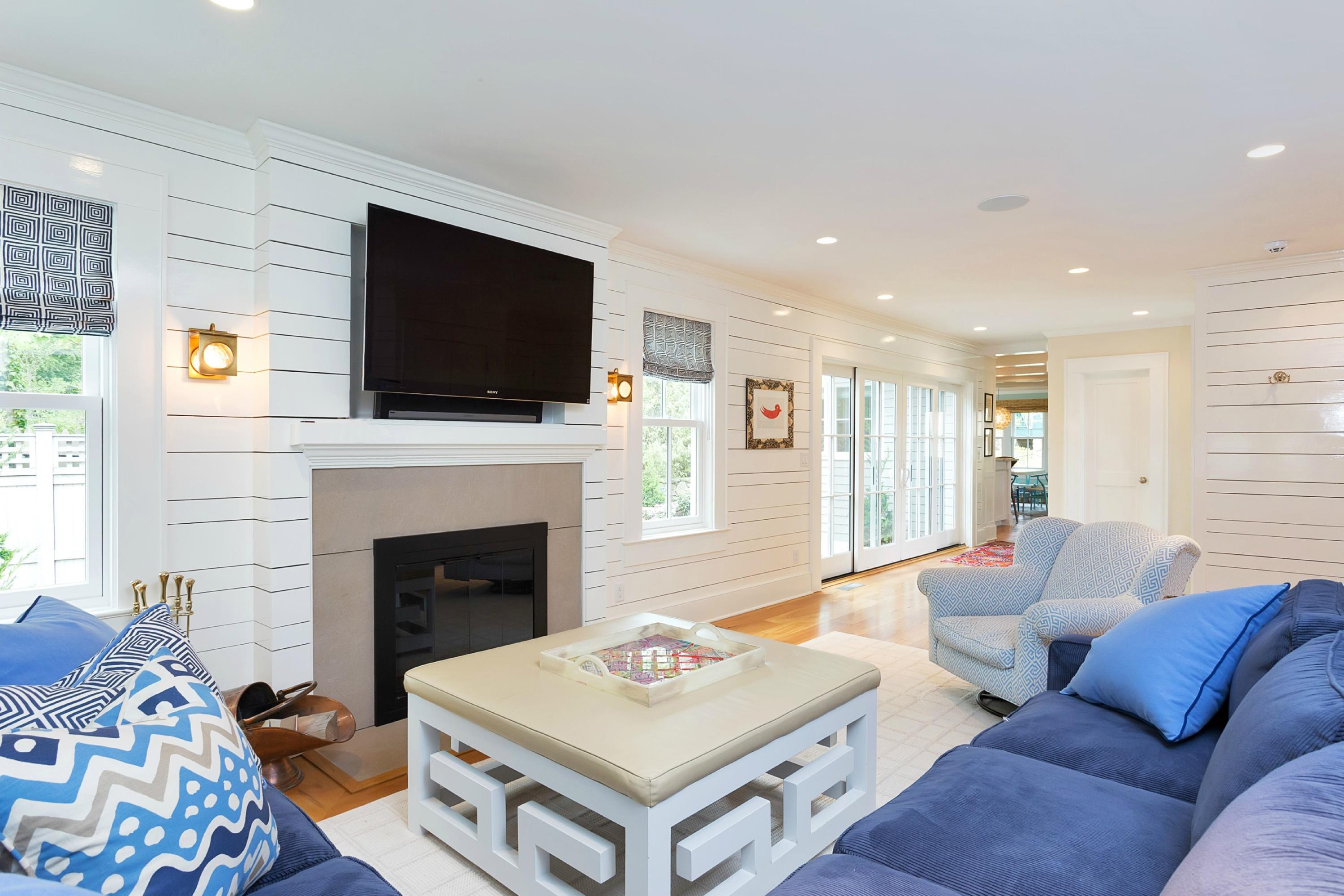 52 Roton Avenue Rowayton, CT 06853 - Photo 4 of 20 a living room with furniture a flat screen tv and a fireplace