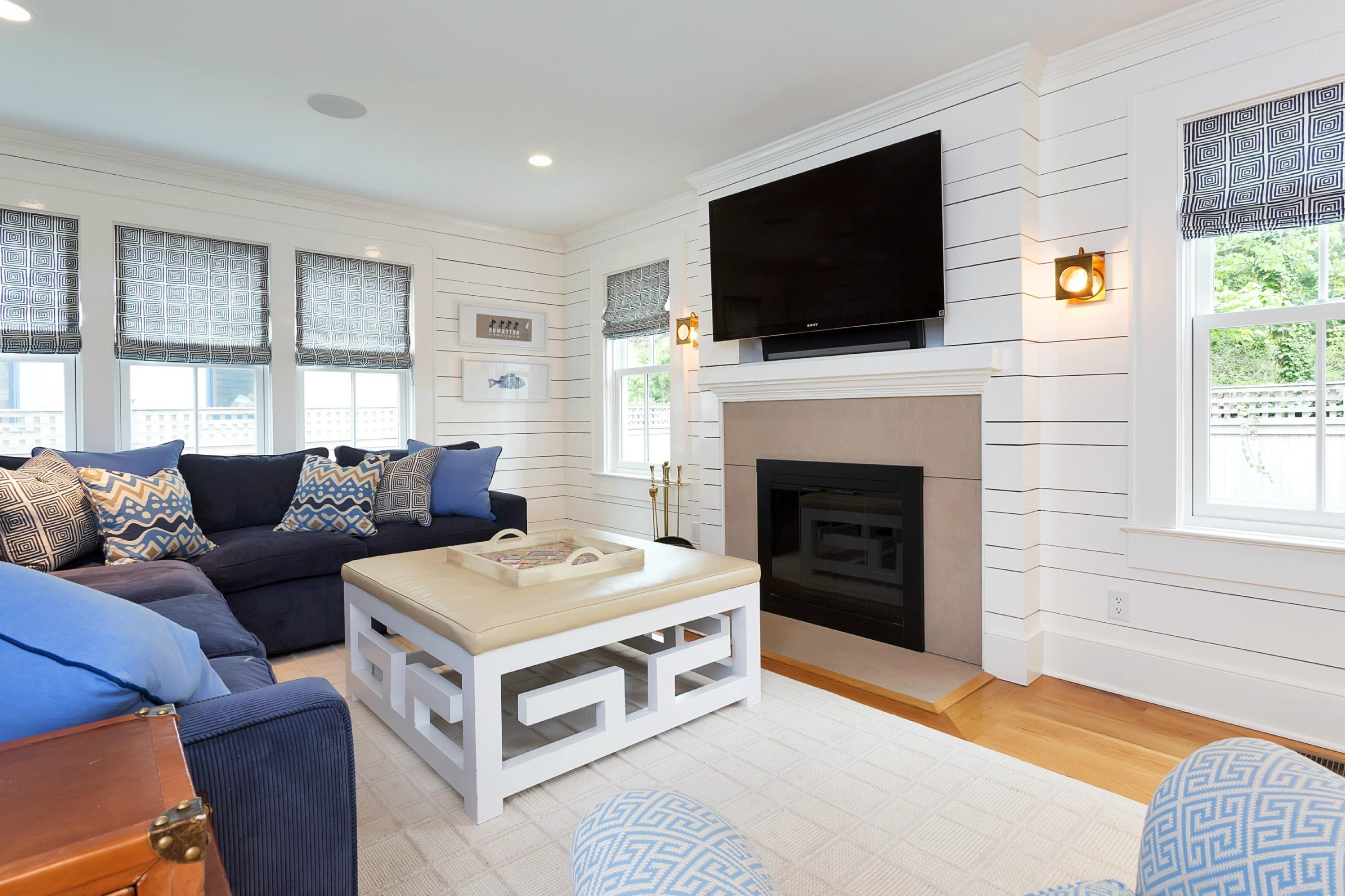 52 Roton Avenue Rowayton, CT 06853 - Photo 5 of 20 a living room with furniture a flat screen tv and a fireplace