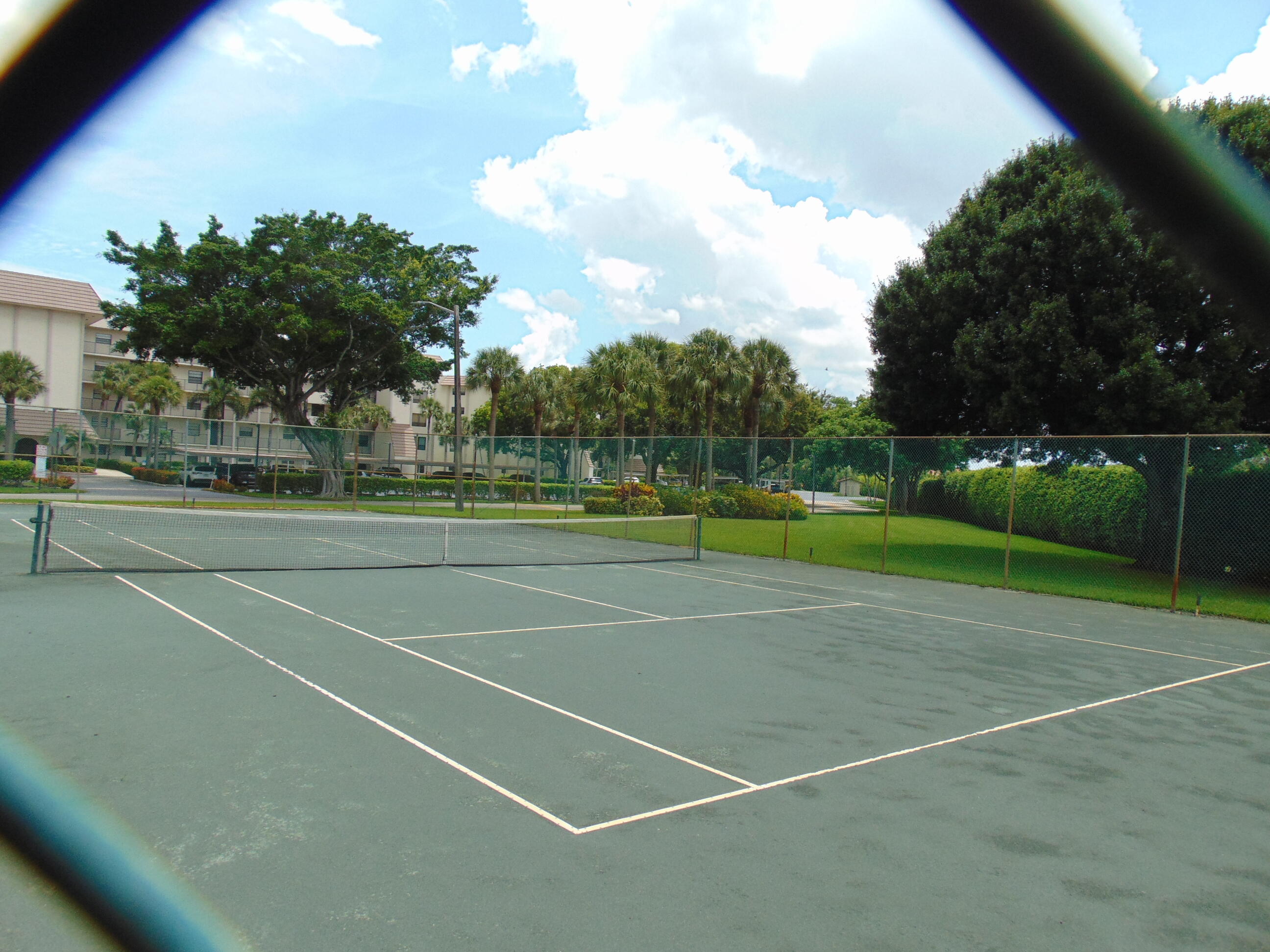 9220 Southwest 14th Street, Unit 3103 Boca Raton, FL 33428 - Photo 8 of 58 a view of a tennis court