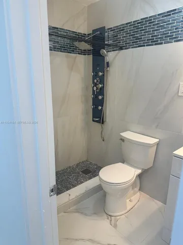 a kitchen with a refrigerator and microwave