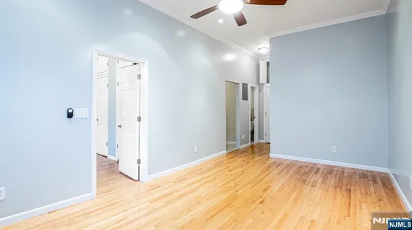 a view of empty room with wooden floor