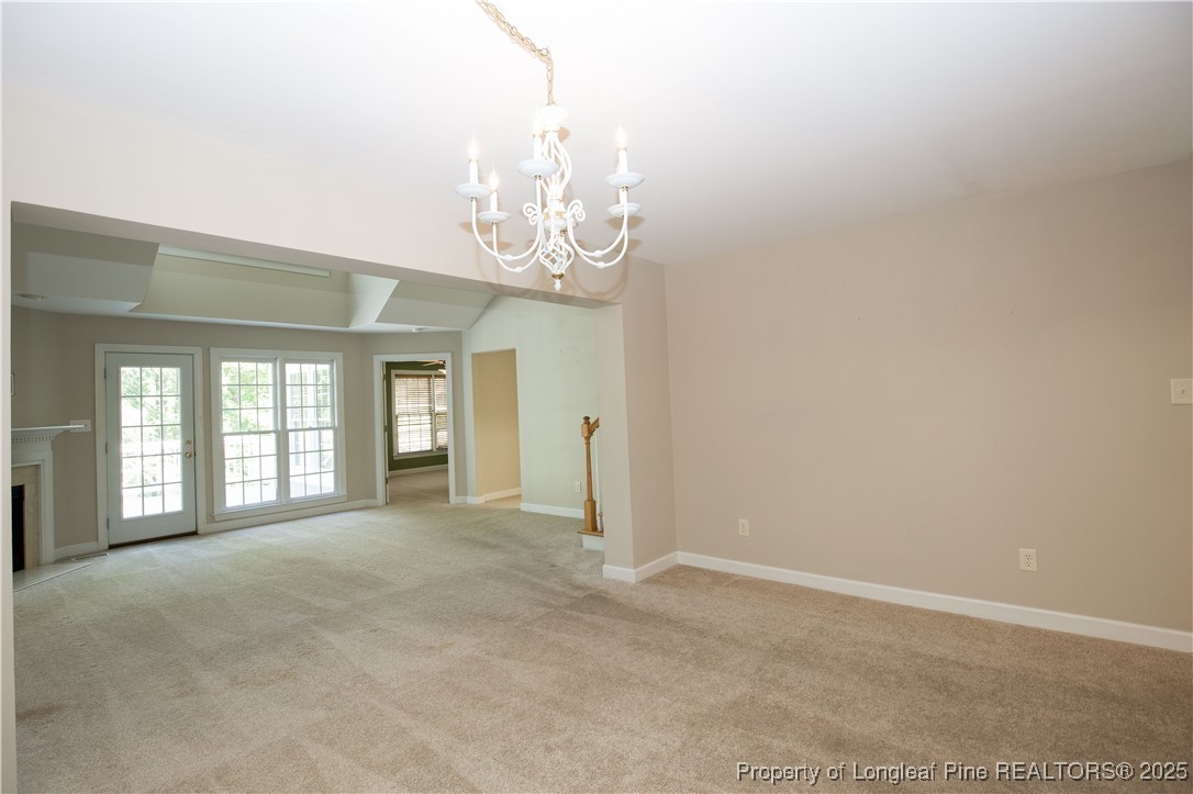 175 Knoll Road Southern Pines, NC 28387 - Photo 16 of 50 a view of a big room with windows and chandelier