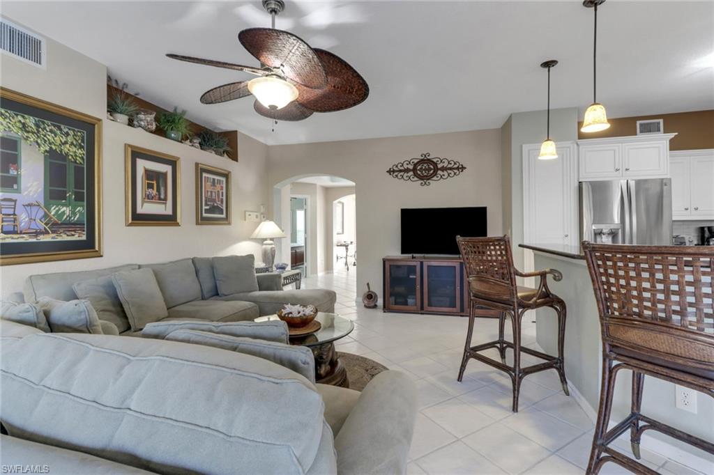 5325 Andover Drive, Unit 101 Naples, FL 34110 - Photo 12 of 25 Tiled living room with ceiling fan