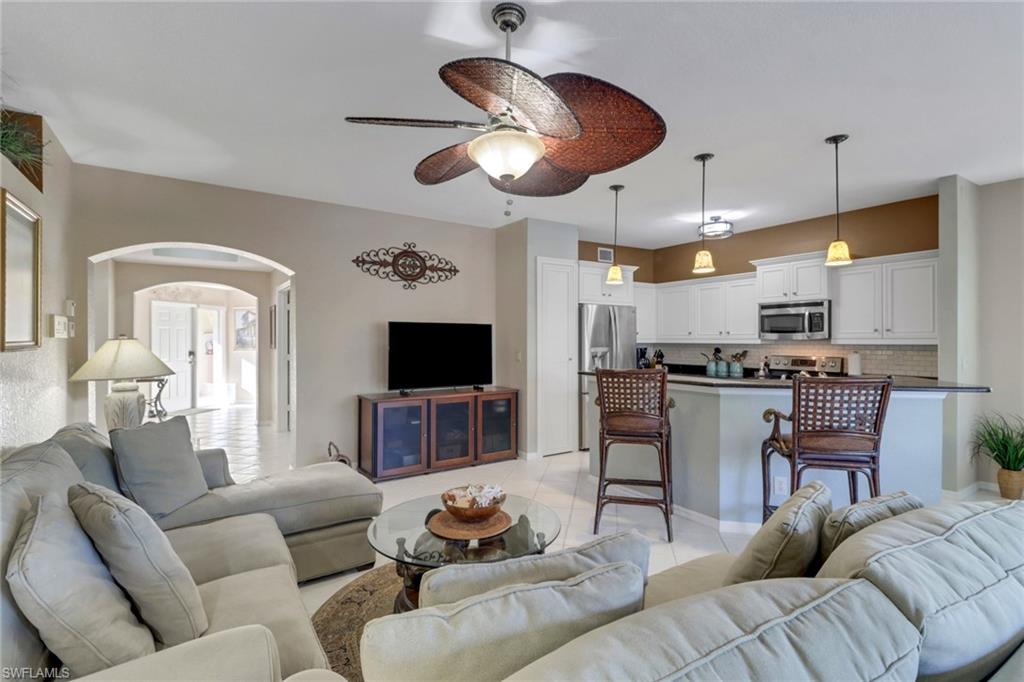 5325 Andover Drive, Unit 101 Naples, FL 34110 - Photo 13 of 25 Living room featuring ceiling fan and light tile patterned flooring
