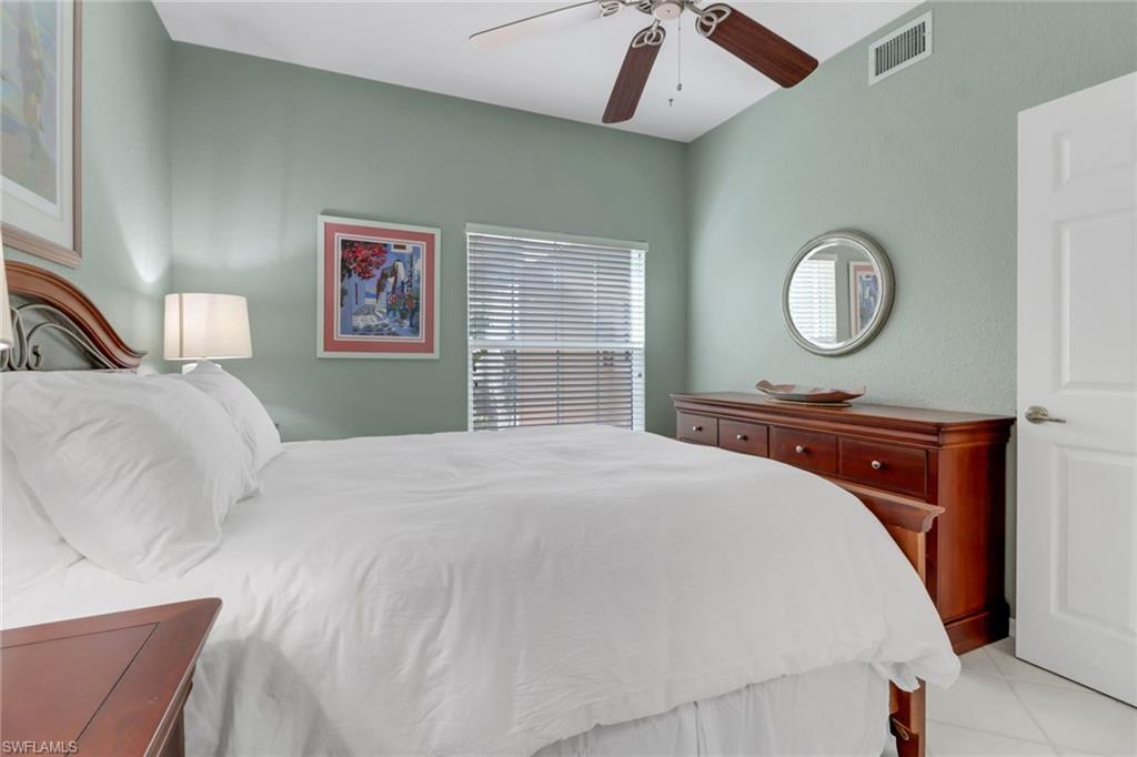 5325 Andover Drive, Unit 101 Naples, FL 34110 - Photo 15 of 25 Bedroom with ceiling fan and light tile patterned flooring