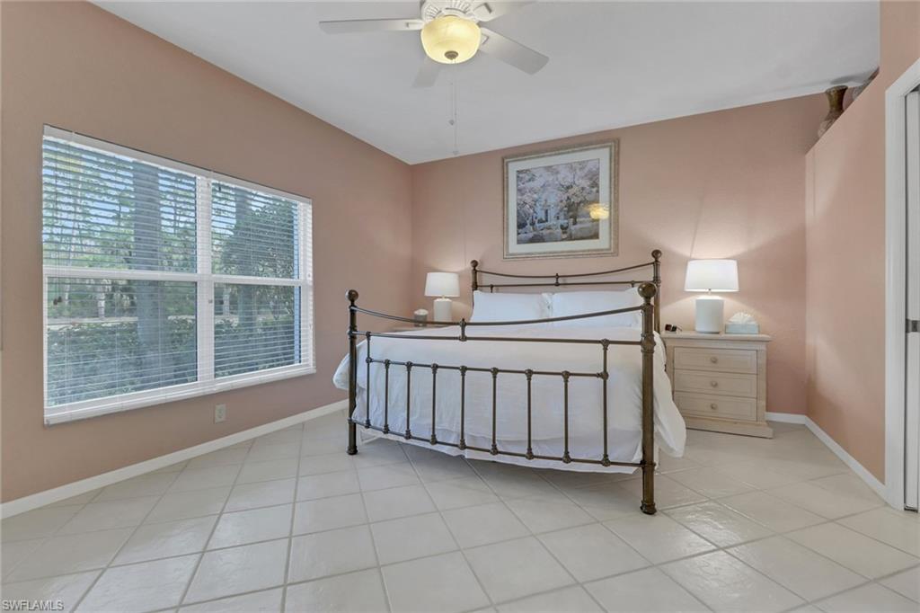 5325 Andover Drive, Unit 101 Naples, FL 34110 - Photo 17 of 25 Tiled bedroom with ceiling fan