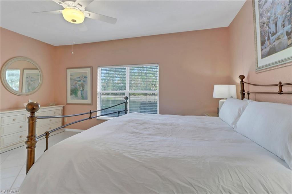 5325 Andover Drive, Unit 101 Naples, FL 34110 - Photo 18 of 25 Tiled bedroom with ceiling fan
