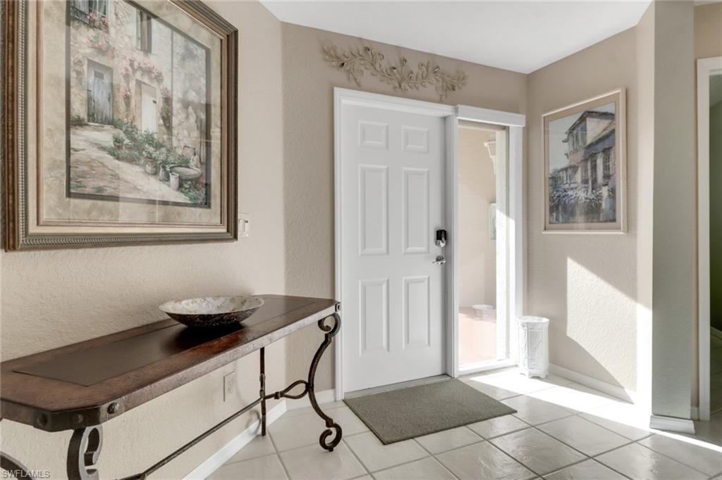 5325 Andover Drive, Unit 101 Naples, FL 34110 - Photo 3 of 25 Entryway with light tile patterned floors