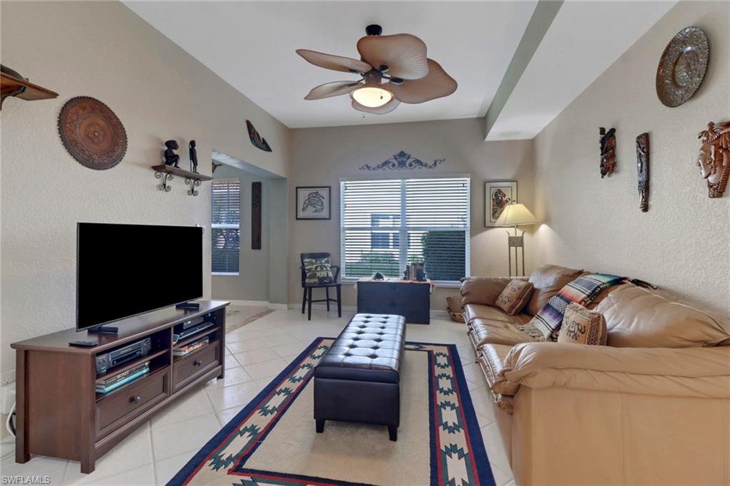5325 Andover Drive, Unit 101 Naples, FL 34110 - Photo 4 of 25 Tiled living room with ceiling fan