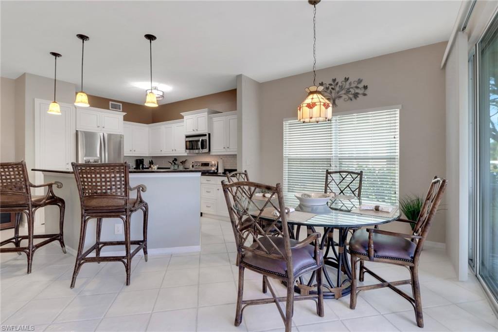 5325 Andover Drive, Unit 101 Naples, FL 34110 - Photo 7 of 25 Dining area featuring light tile patterned flooring