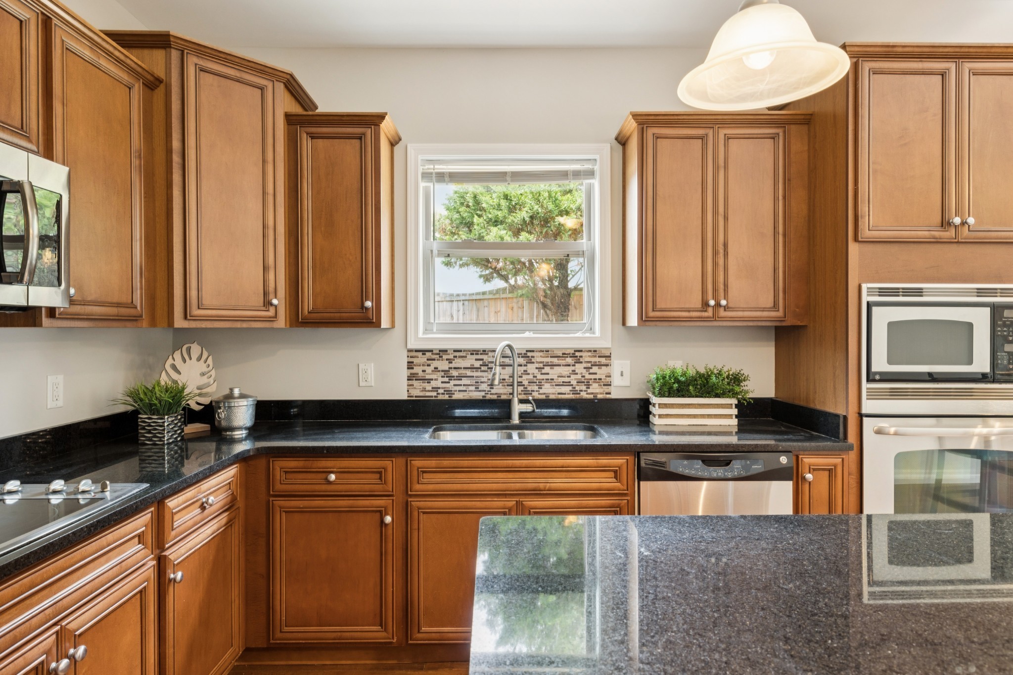 2040 Belshire Way Spring Hill, TN 37174 - Photo 18 of 74 a kitchen with stainless steel appliances granite countertop a stove a sink and a microwave