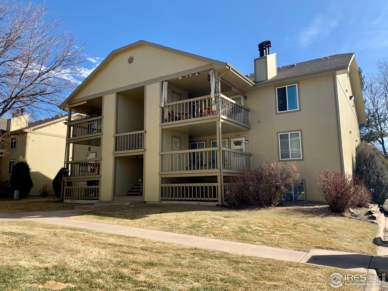 1672 Riverside Avenue, Unit 116 Fort Collins, CO 80525 - Photo 1 of 39 a front view of a house with a yard