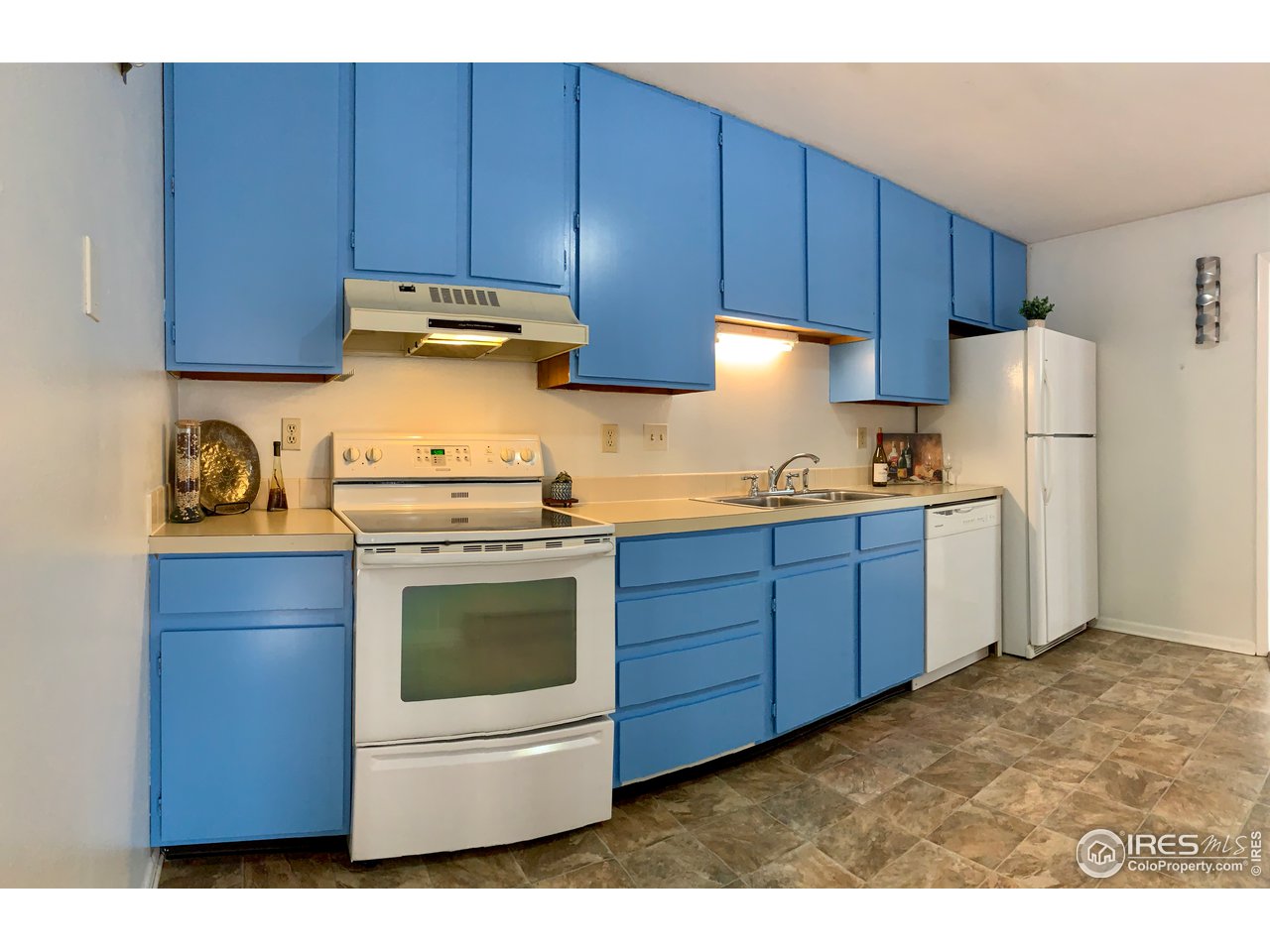 1672 Riverside Avenue, Unit 116 Fort Collins, CO 80525 - Photo 13 of 39 a kitchen with a sink a stove and refrigerator