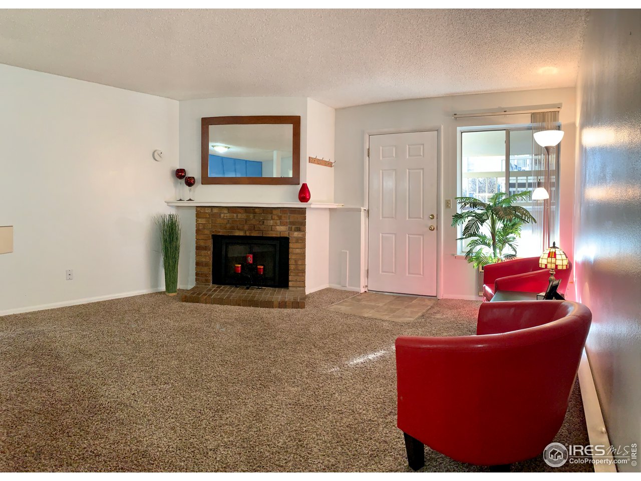 1672 Riverside Avenue, Unit 116 Fort Collins, CO 80525 - Photo 14 of 39 a living room with furniture a fireplace and a window