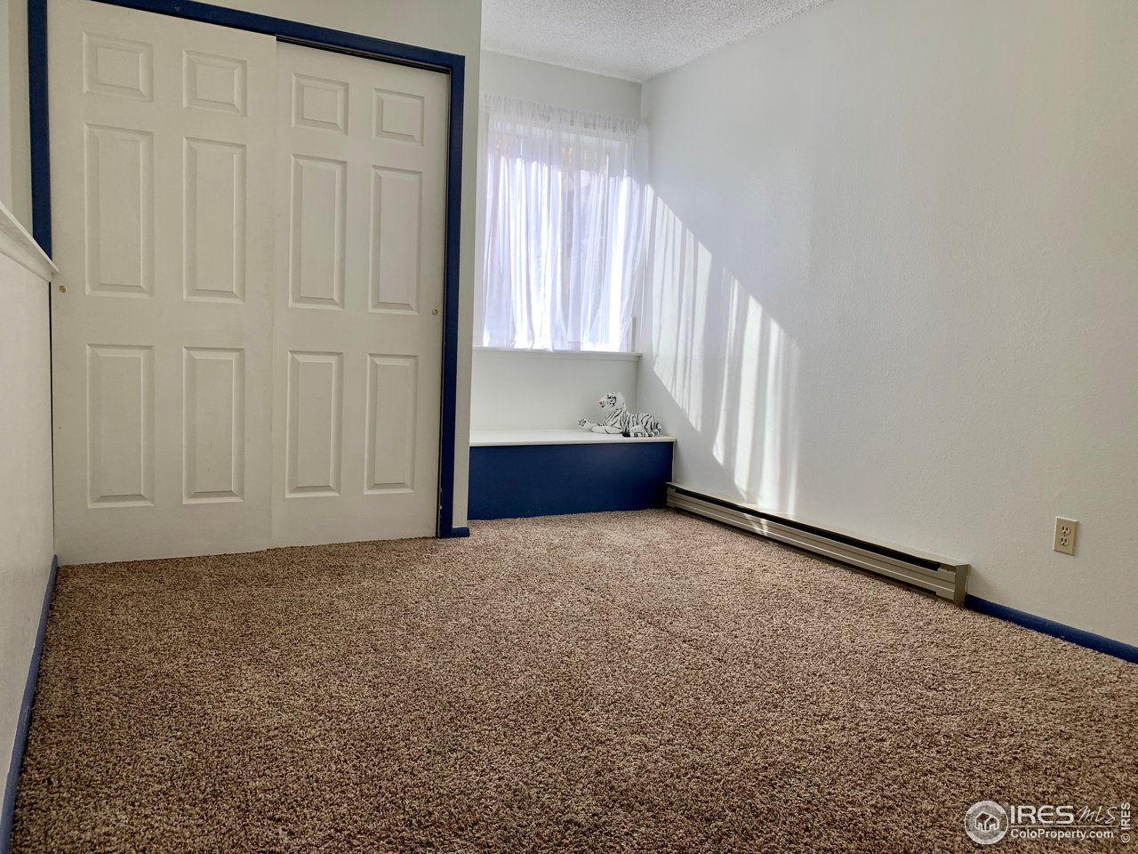 1672 Riverside Avenue, Unit 116 Fort Collins, CO 80525 - Photo 20 of 39 a view of an empty room and window