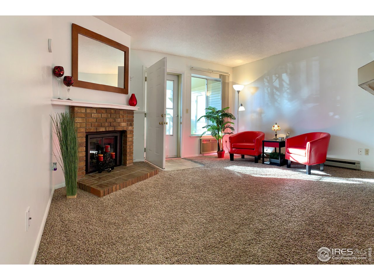 1672 Riverside Avenue, Unit 116 Fort Collins, CO 80525 - Photo 2 of 39 a living room with furniture window and fireplace