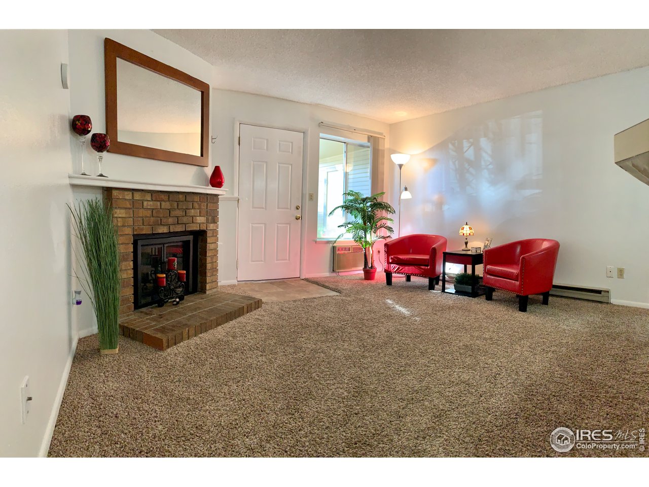 1672 Riverside Avenue, Unit 116 Fort Collins, CO 80525 - Photo 26 of 39 a living room with furniture a window and a fireplace