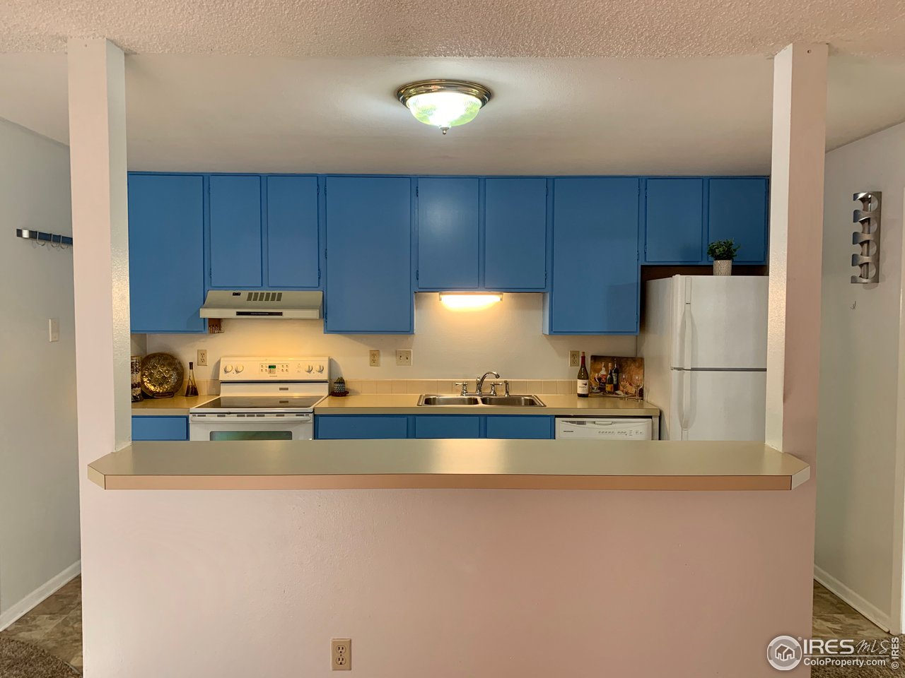 1672 Riverside Avenue, Unit 116 Fort Collins, CO 80525 - Photo 27 of 39 a kitchen with stainless steel appliances a refrigerator a stove a sink and a refrigerator
