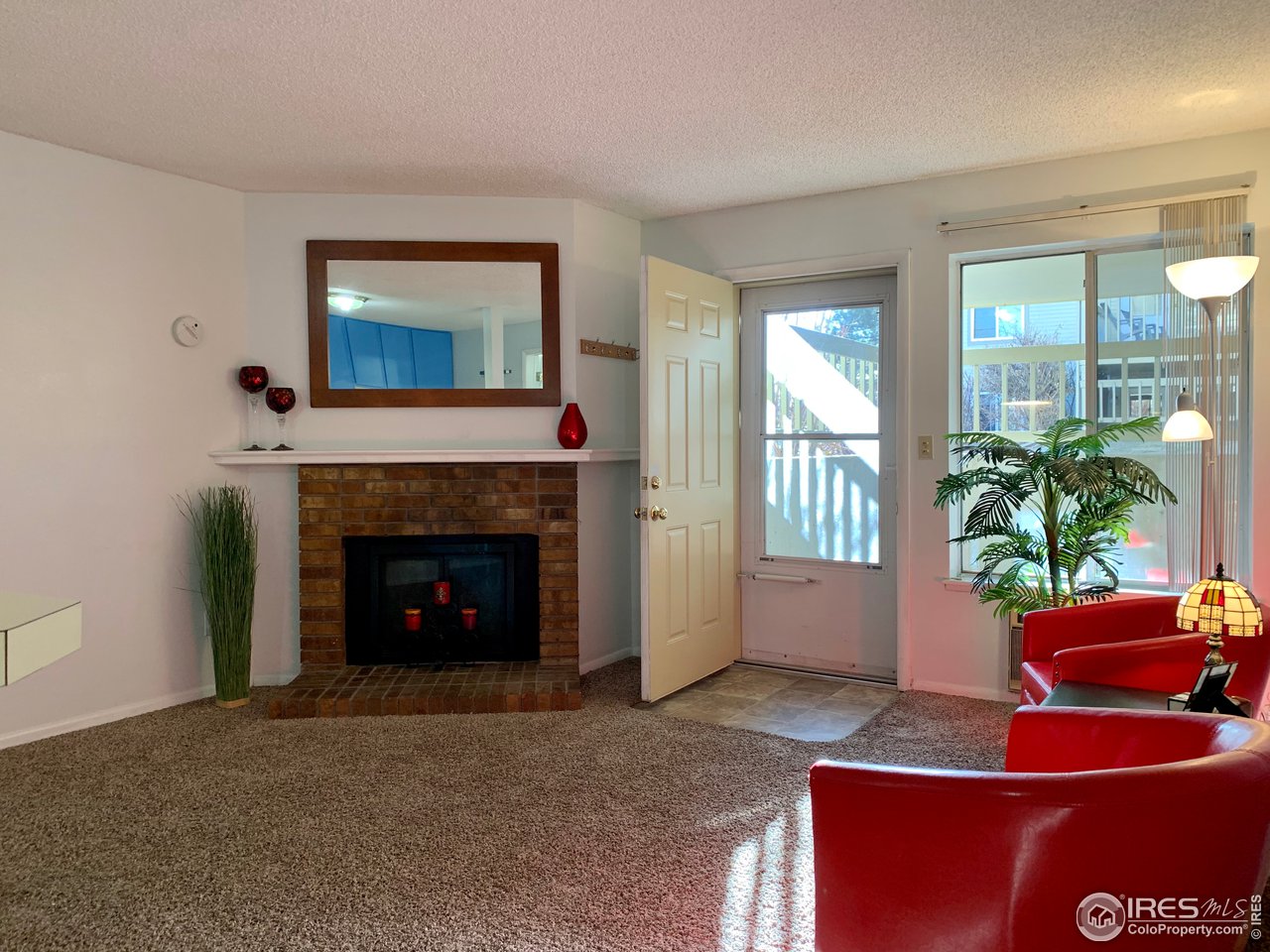 1672 Riverside Avenue, Unit 116 Fort Collins, CO 80525 - Photo 28 of 39 a living room with furniture and a fireplace