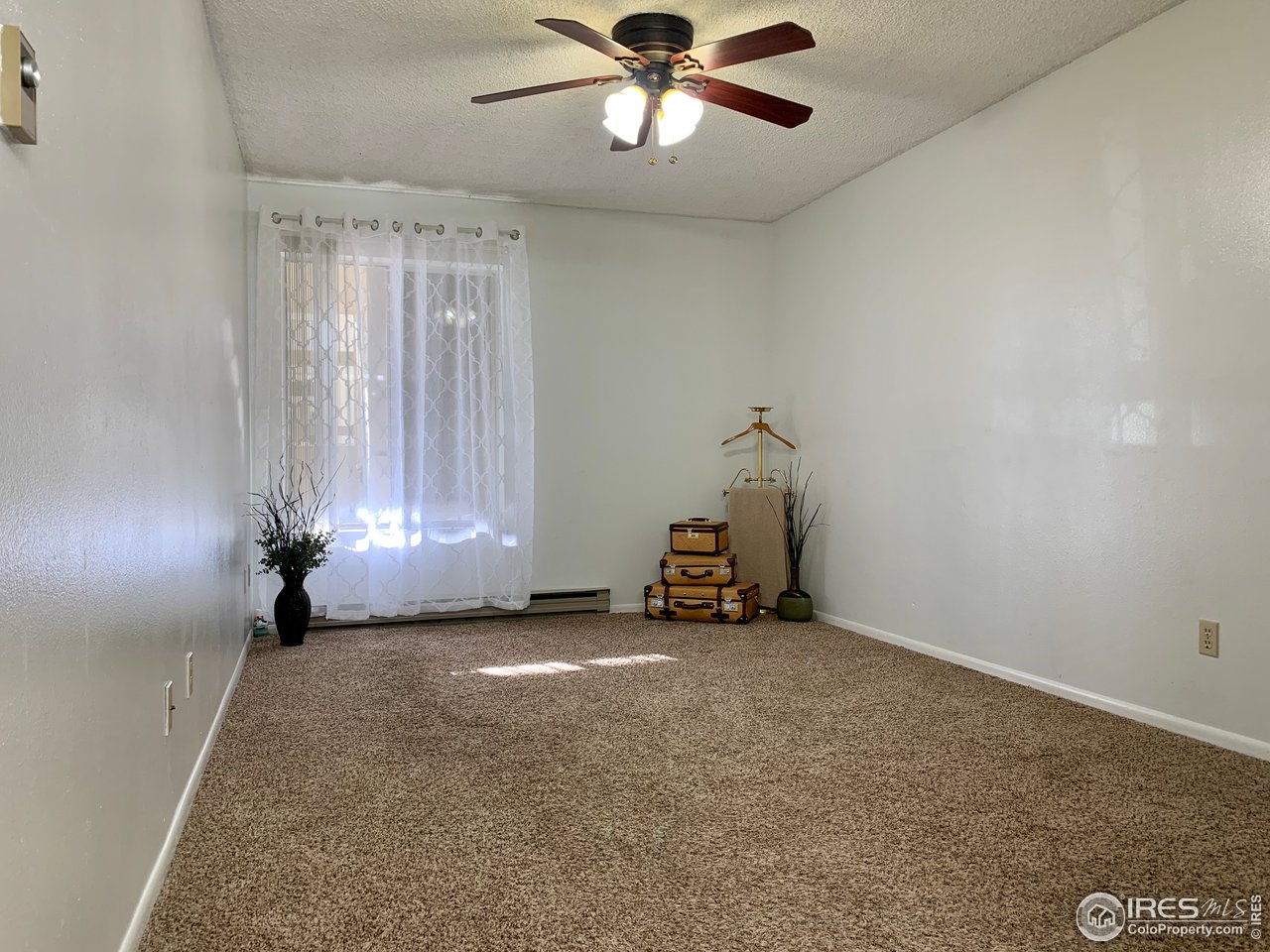 1672 Riverside Avenue, Unit 116 Fort Collins, CO 80525 - Photo 4 of 39 a view of an empty room and window
