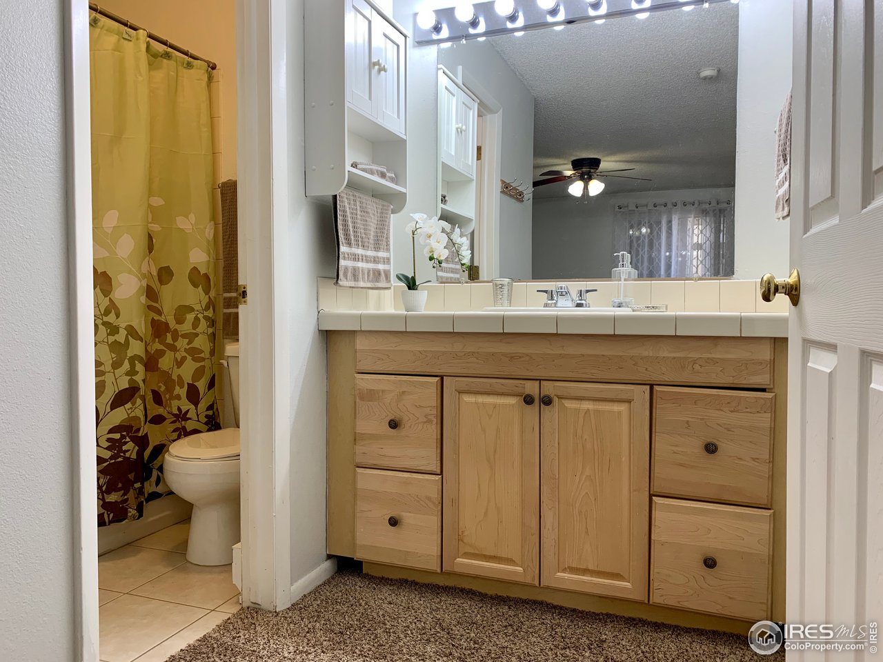 1672 Riverside Avenue, Unit 116 Fort Collins, CO 80525 - Photo 5 of 39 a bathroom with a granite countertop sink toilet and shower