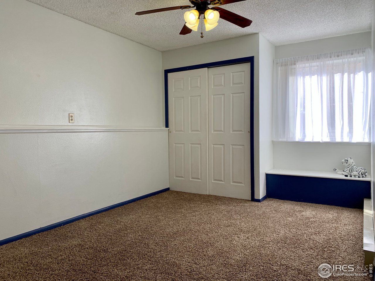 1672 Riverside Avenue, Unit 116 Fort Collins, CO 80525 - Photo 7 of 39 an empty room with chandelier fan