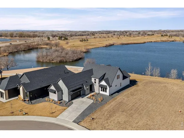 an aerial view of a house with a lake view