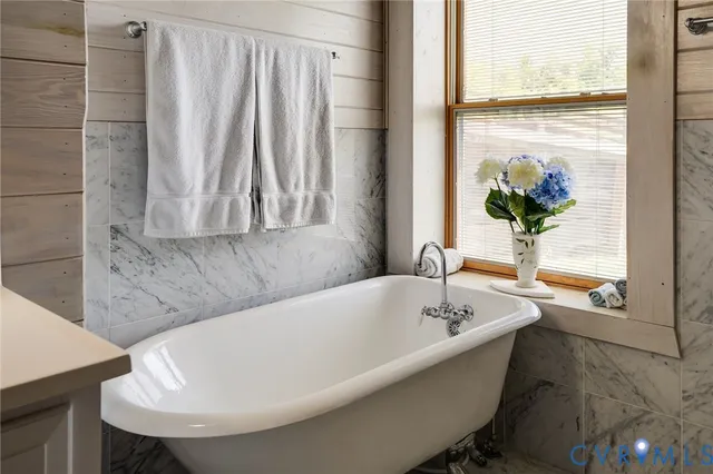 a roof deck with couches and wooden fence