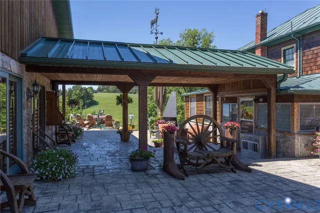 a view of a chairs and table in the back yard of the house