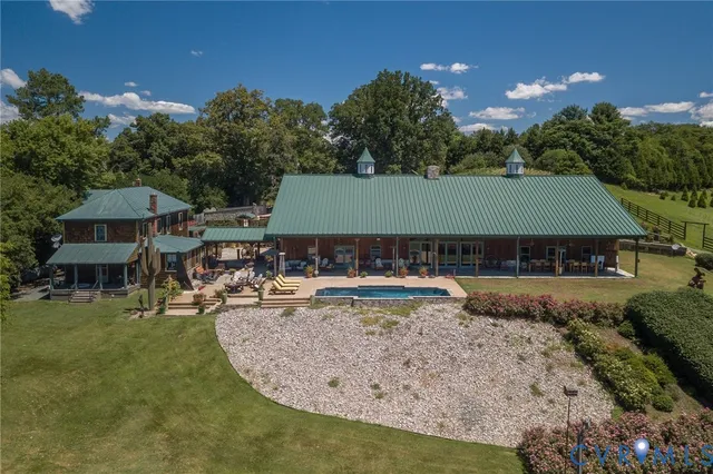 a view of a house with pool and chairs