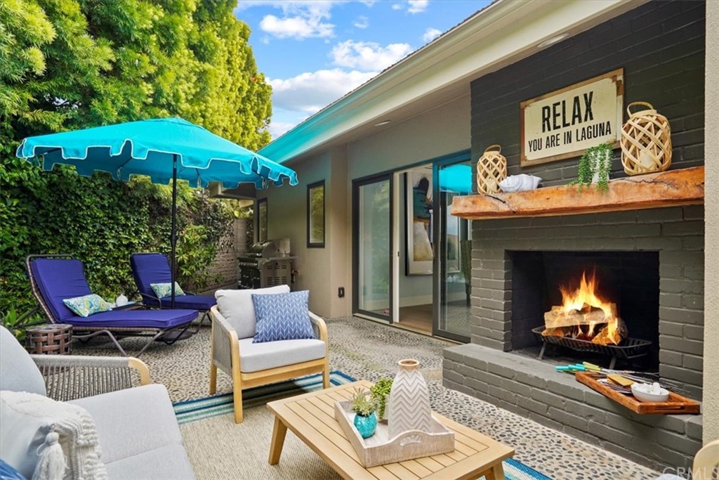a outdoor living space with furniture and a fireplace