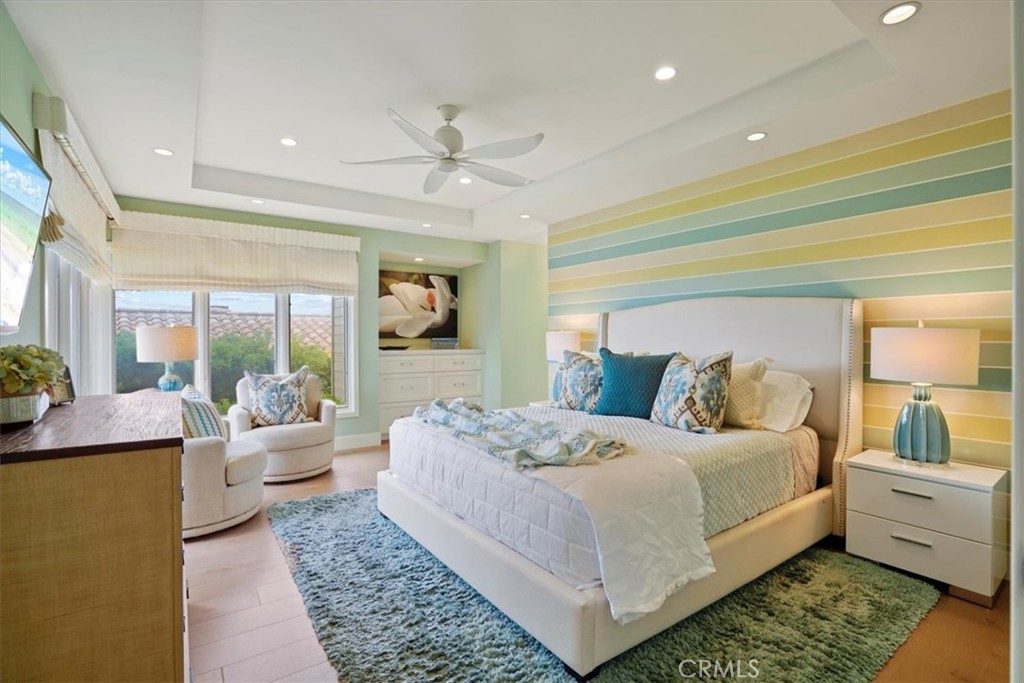 437 Emerald Bay Laguna Beach, CA 92651 - Photo 14 of 61 a large bedroom with a large bed and a chandelier