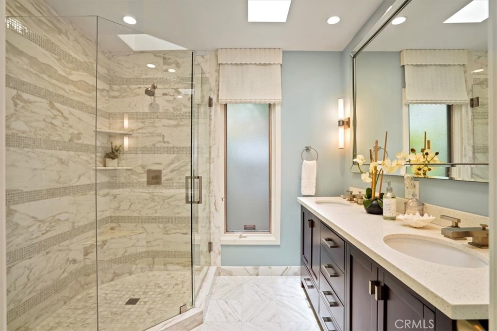 437 Emerald Bay Laguna Beach, CA 92651 - Photo 25 of 61 a bathroom with a double vanity sink mirror and shower