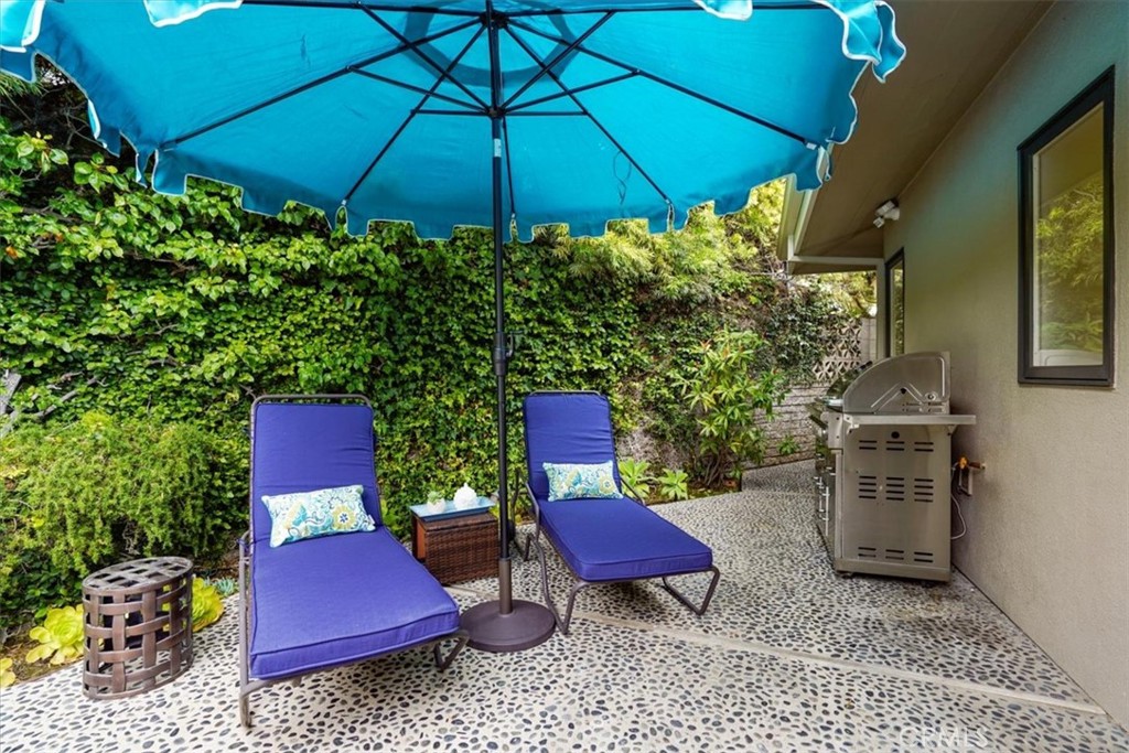 437 Emerald Bay Laguna Beach, CA 92651 - Photo 31 of 61 a view of a backyard with table and chairs under an umbrella