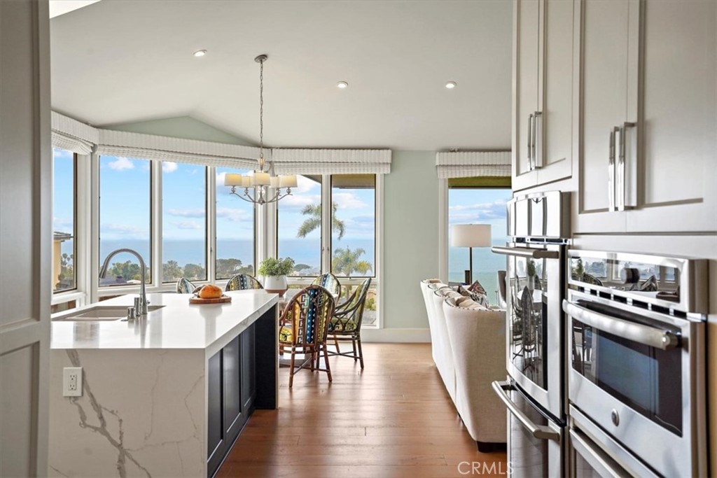 437 Emerald Bay Laguna Beach, CA 92651 - Photo 41 of 61 a kitchen with stainless steel appliances granite countertop a stove a refrigerator a kitchen island a dining table and chairs