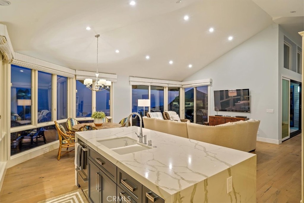 437 Emerald Bay Laguna Beach, CA 92651 - Photo 44 of 61 a large white kitchen with a large island in the center