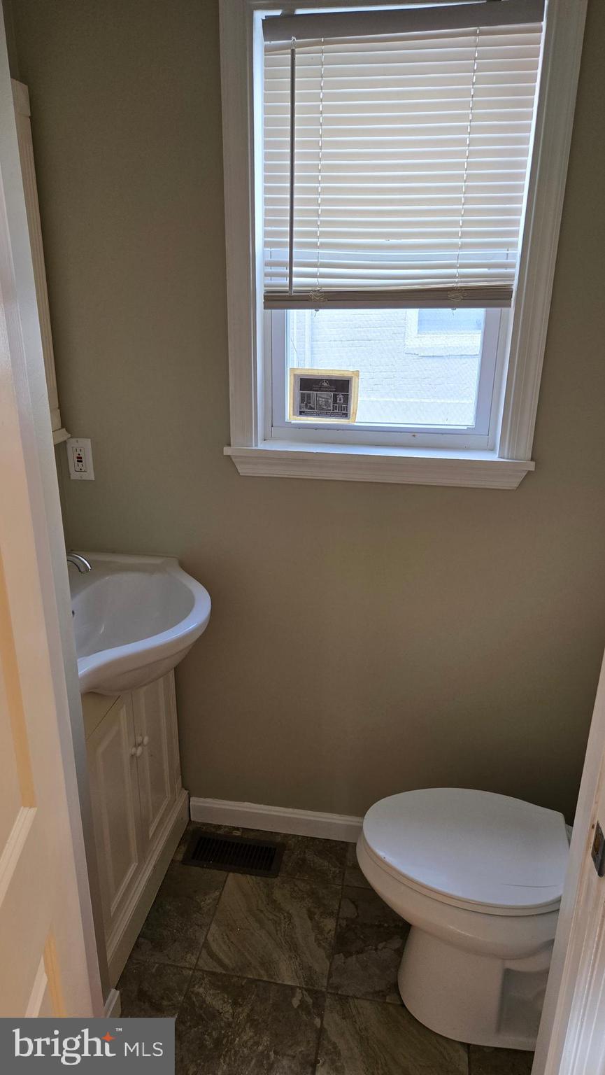 638 Wyeth Street Baltimore, MD 21230 - Photo 5 of 14 a bathroom with a toilet and a sink
