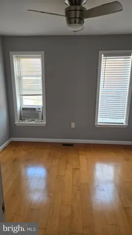 a view of a room with window and wooden floor