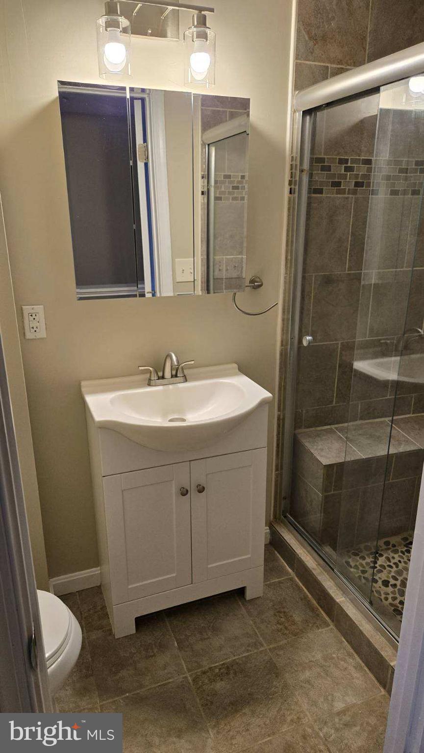 638 Wyeth Street Baltimore, MD 21230 - Photo 8 of 14 a bathroom with a sink a toilet and shower