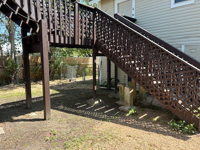 4725 Avenue R 1/2 Galveston, TX 77551 - Photo 16 of 18 a view of a patio with table and chairs a floor to ceiling window with wooden fence