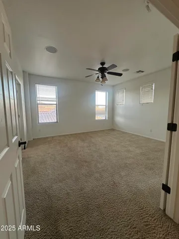 a view of an empty room with a ceiling fan