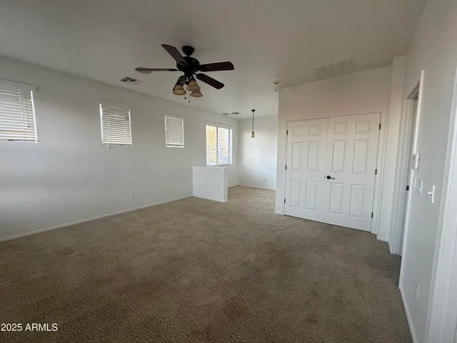 a view of a big room with windows and fireplace